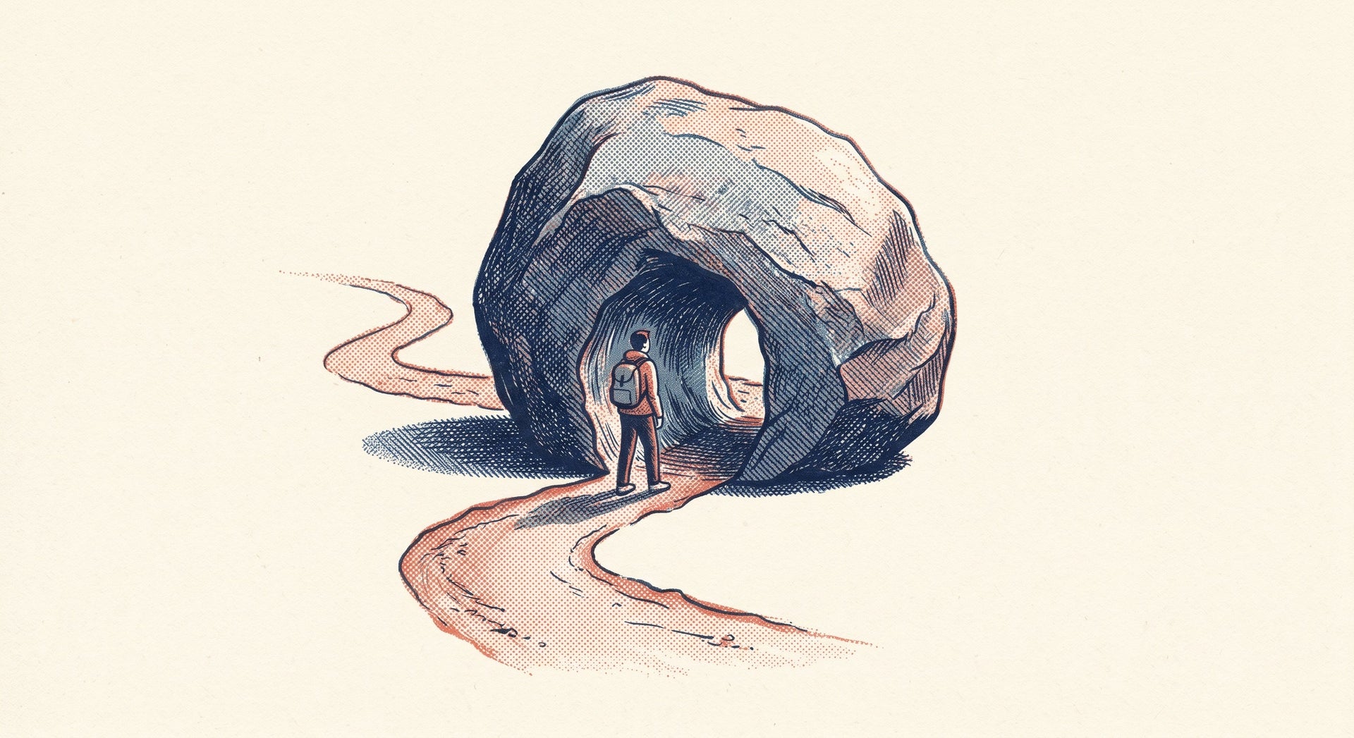 A boulder on a winding trail with a narrow path carved through its centre