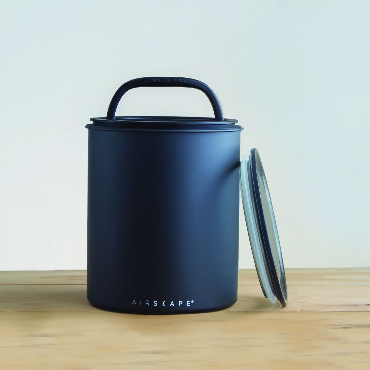 Airscape Kilo canister with coffee beans inside showing vacuum seal
