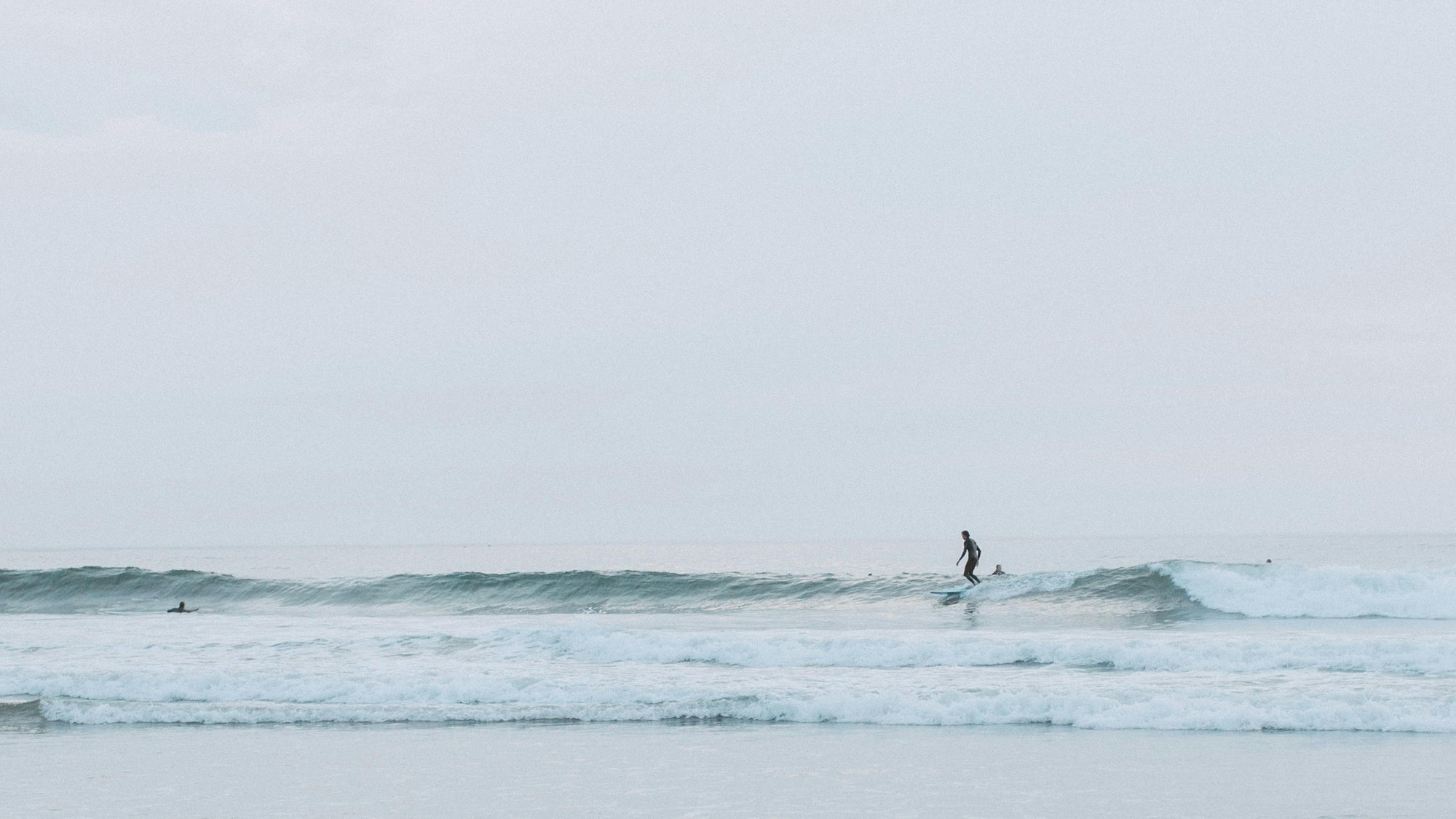 Morning surfer riding a wave