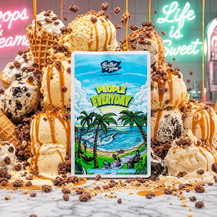 A People Everyday bag in front of a stack of ice cream scoops running with caramel, under a neon sign that says Life is Sweet